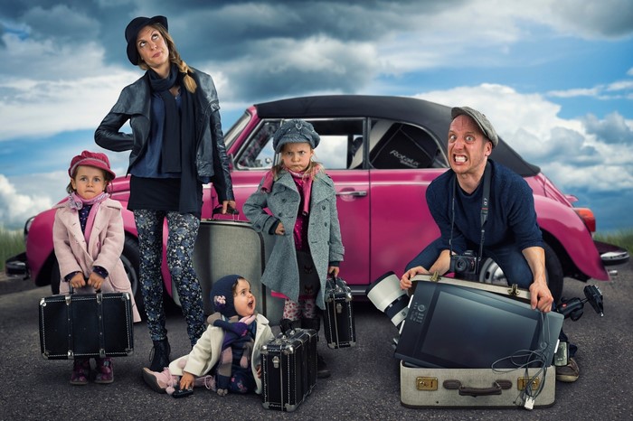 Family with luggage and pink car