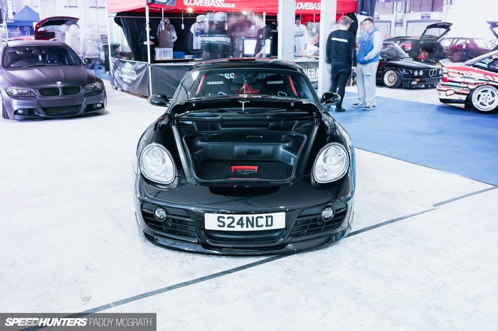 Black Porsche Cayman with open trunk at car show