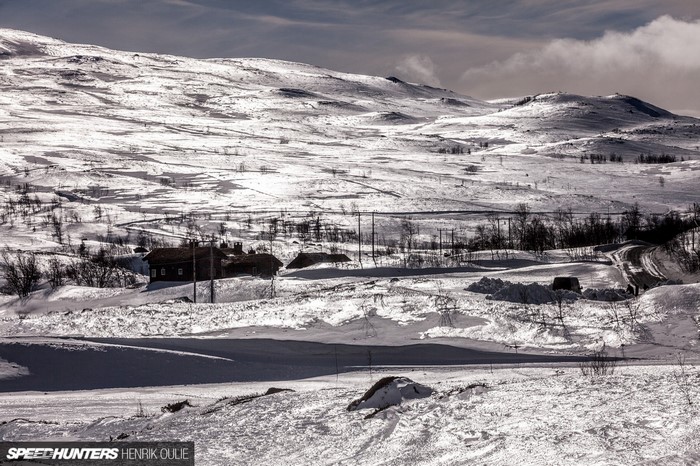 Snowy landscape with houses and a road