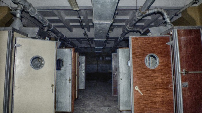 Abandoned industrial corridor with rows of doors