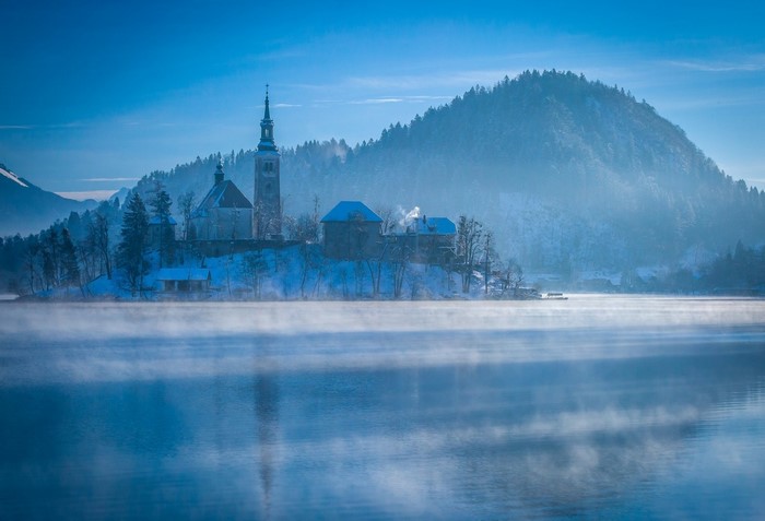Winter morning mist over Lake Bled with a church on an island