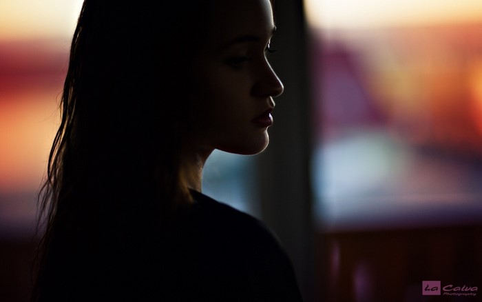 Woman in silhouette with blurred colorful background
