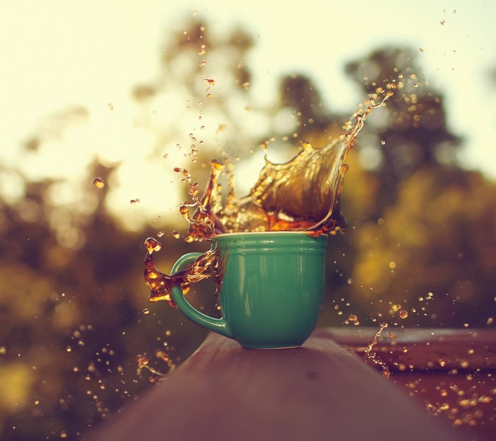 Coffee splash from a green mug outdoors