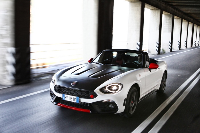 White Abarth 124 Spider driving through a tunnel