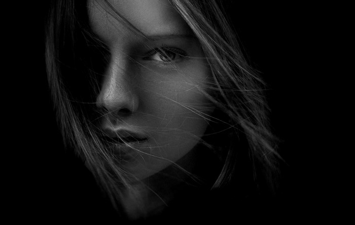 Monochrome portrait of a woman with hair blowing