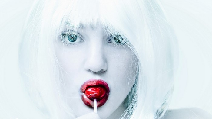 Woman with white hair and red lollipop