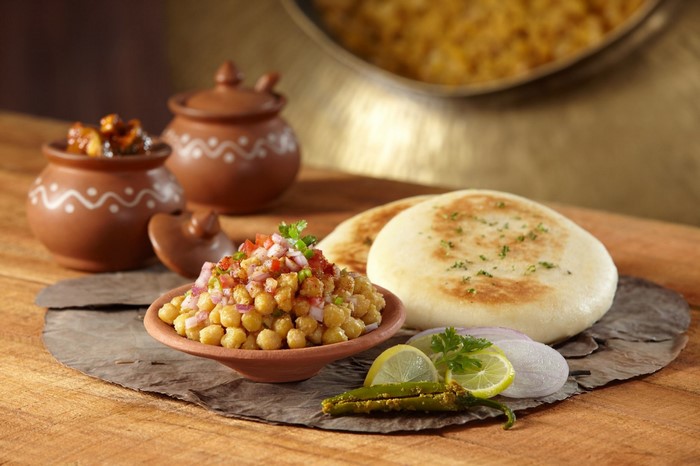 Indian chickpea dish with naan and pickles