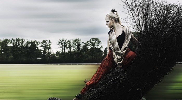 Woman in red skirt and scarf posing outdoors
