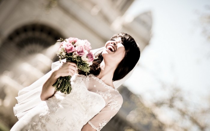 Bride laughing with a bouquet