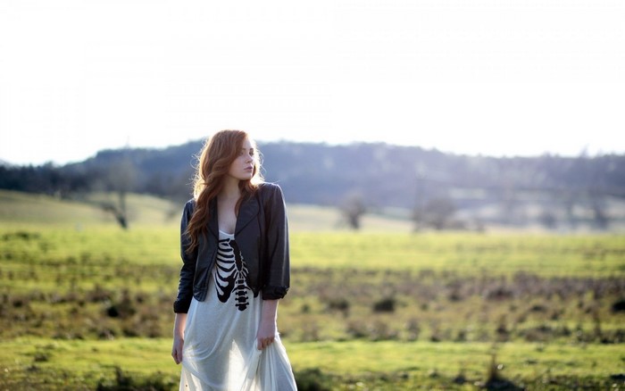 Woman with red hair in a field
