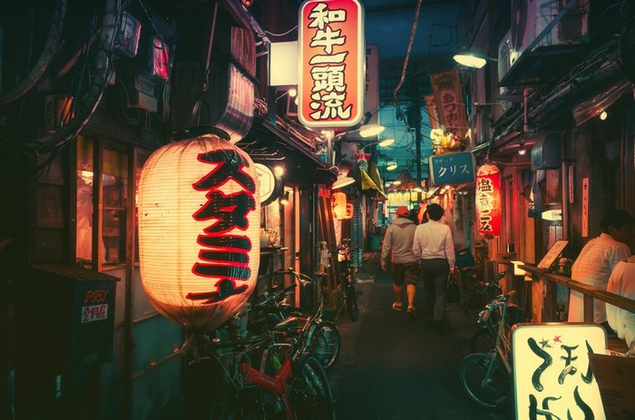 Night alley in Japan with lanterns and people