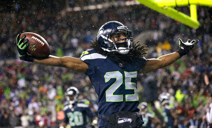Richard Sherman of the Seattle Seahawks holding a football