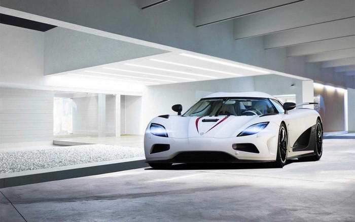 White Koenigsegg sports car in modern garage