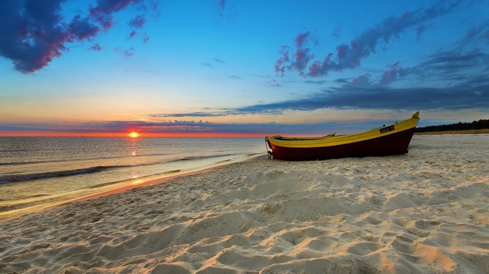 Boat on a beach at sunset