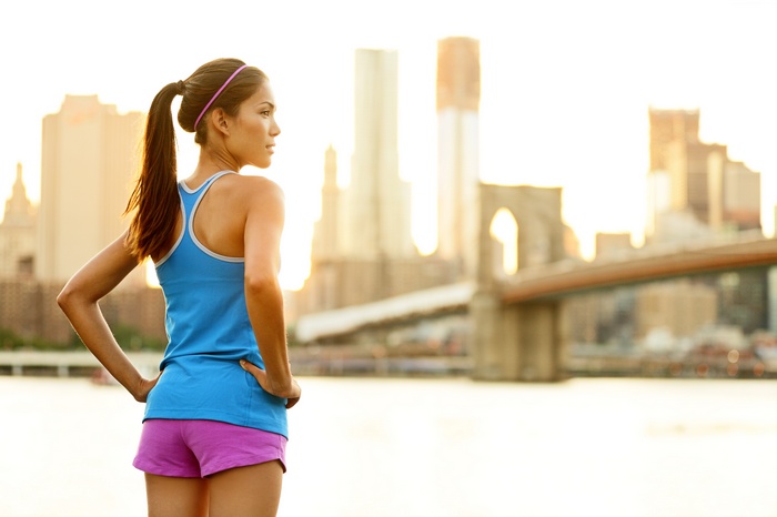 Woman in sportswear looking at New York City skyline