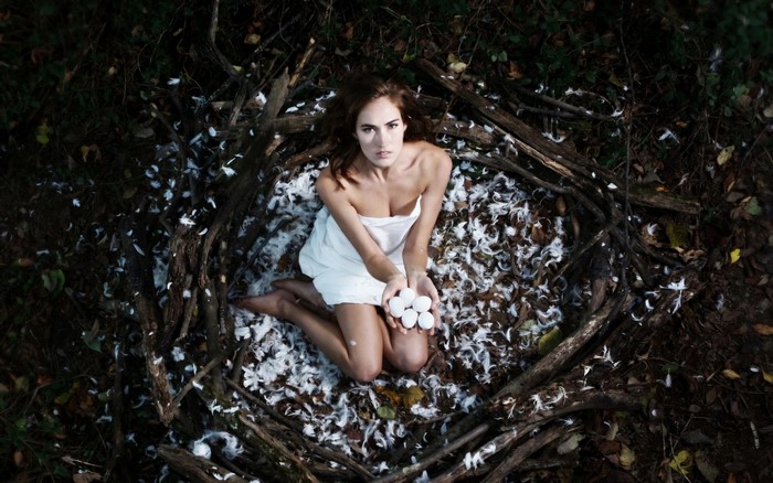 Woman Kneeling in Forest Nest with Eggs