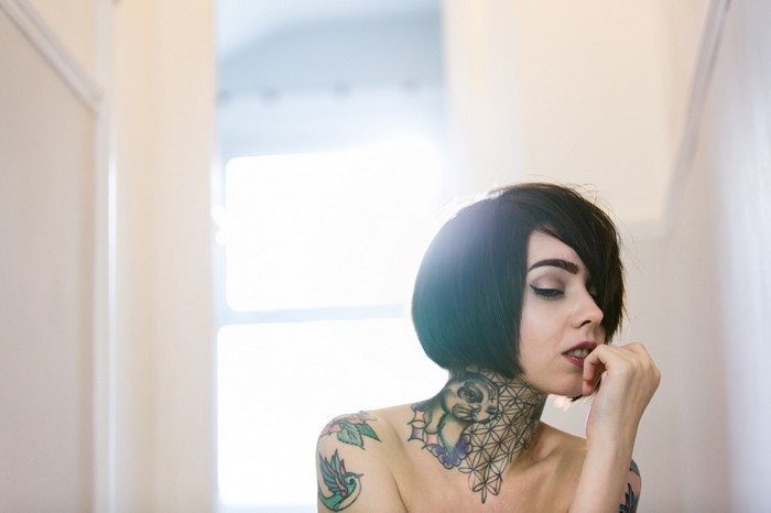 Woman with tattoos and short dark hair
