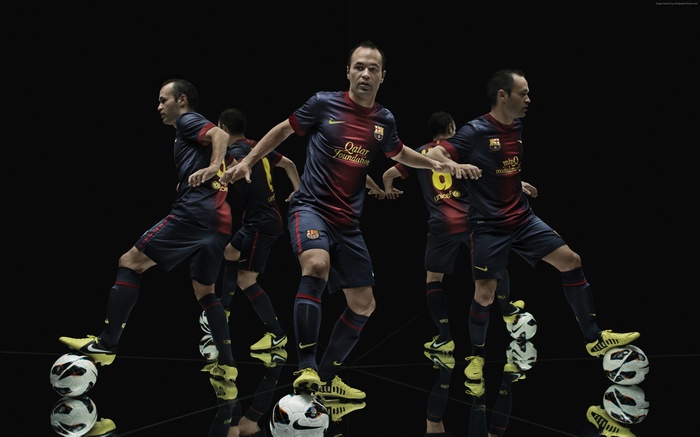 Andres Iniesta with Barcelona football kit and soccer balls