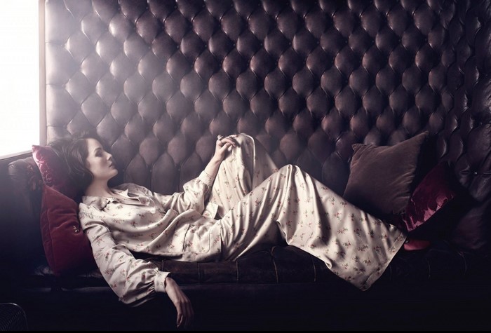 Michelle Dockery on a tufted leather couch