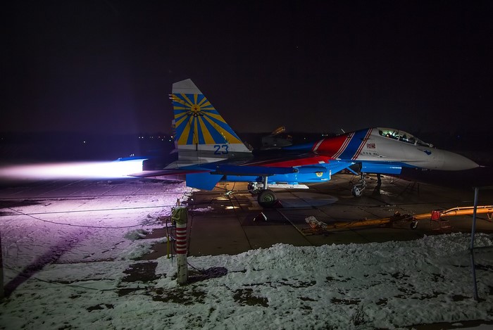 Su-27 fighter jet with engine exhaust at night