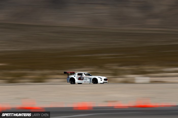 White Mercedes-Benz SLS AMG racing on a track