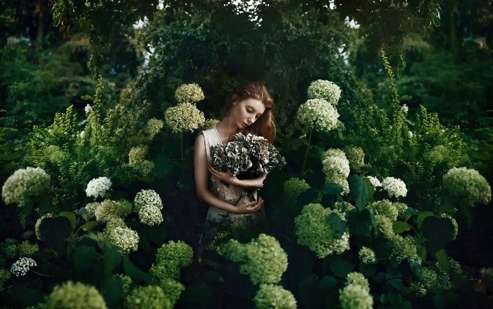 Woman holding flowers in a garden