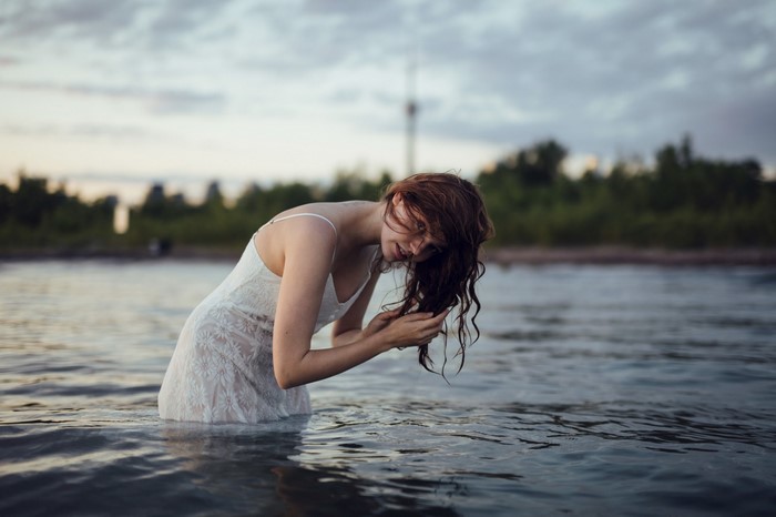 Woman in white dress in water