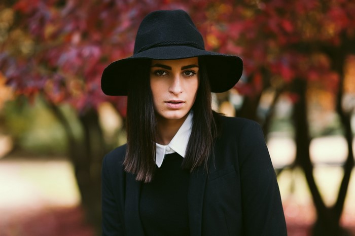 Woman wearing a black fedora and blazer