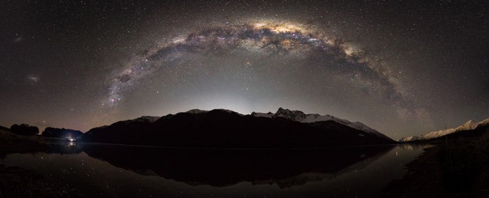 Milky Way galaxy over mountains and lake at night