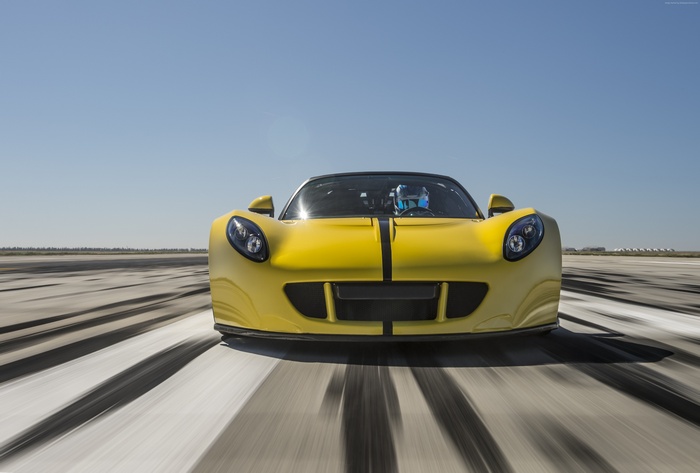 Yellow Hennessey Venom GT Spyder racing on a track