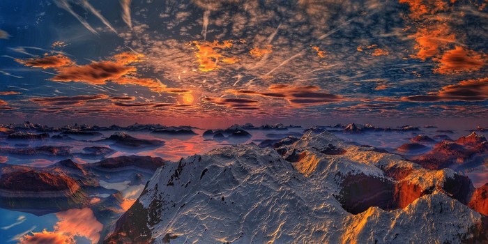 Snowy mountains at sunset with clouds and reflection