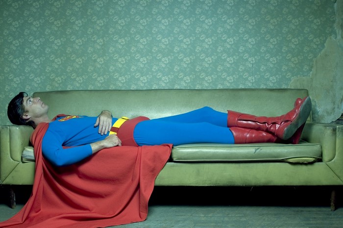 Superman lying on a couch