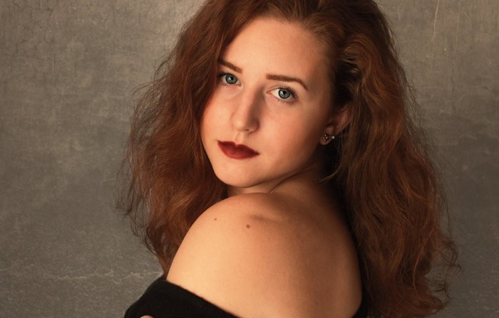 Woman with red hair and dark lipstick