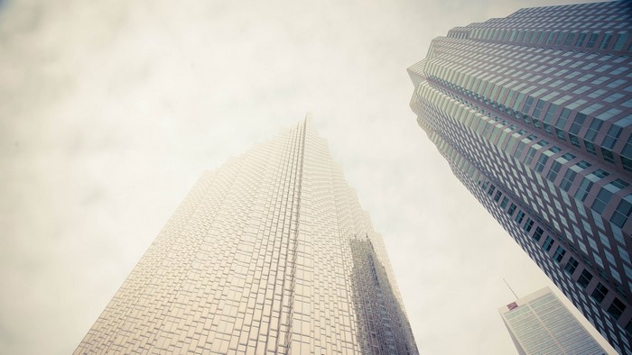 Skyscrapers viewed from below against a cloudy sky