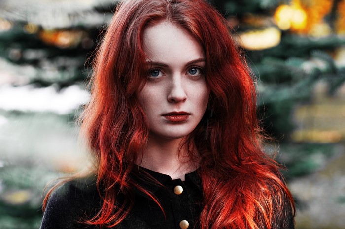 Woman with long red hair wearing a black top