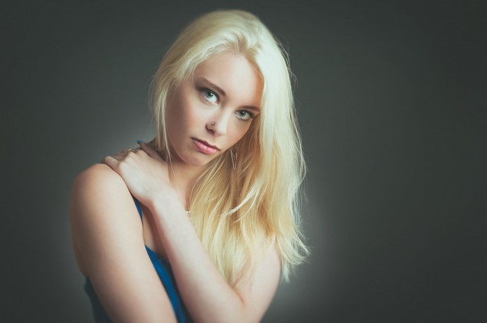Woman with blonde hair in a blue top