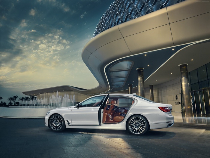 White BMW 750Li xDrive Solitaire parked outside modern building