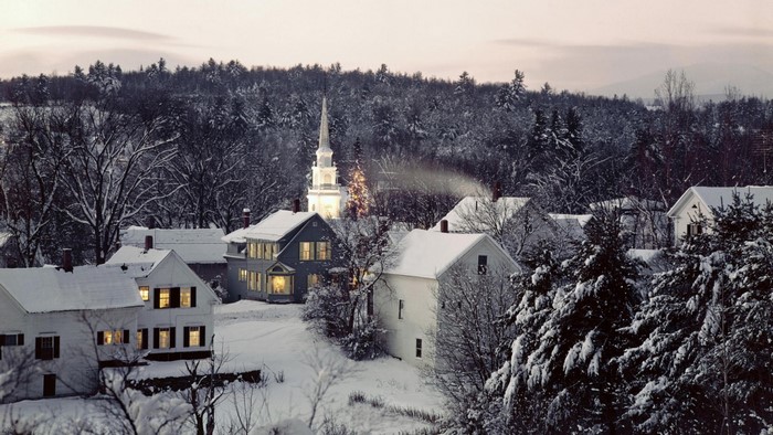 Snowy village with church and Christmas tree