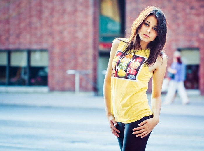 Woman in yellow tank top with macarons print