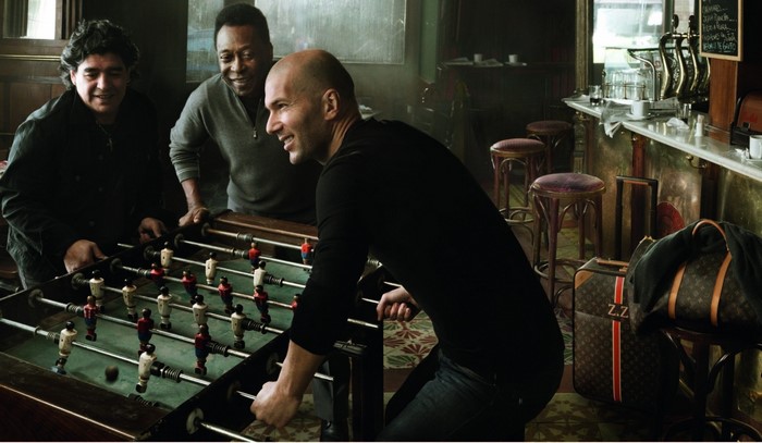 Diego Maradona, Pelé, and Zinedine Zidane play foosball