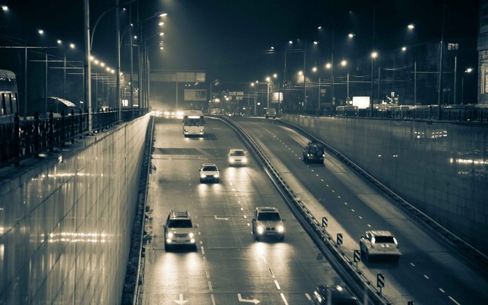 Night highway with cars and street lights