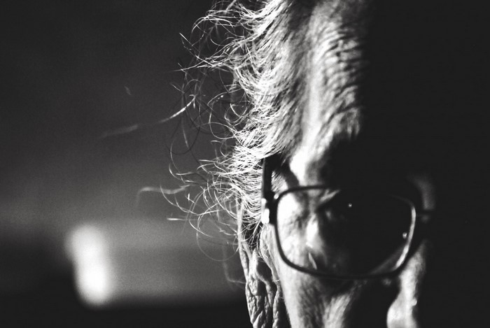 Close up of an elderly person's face with glasses