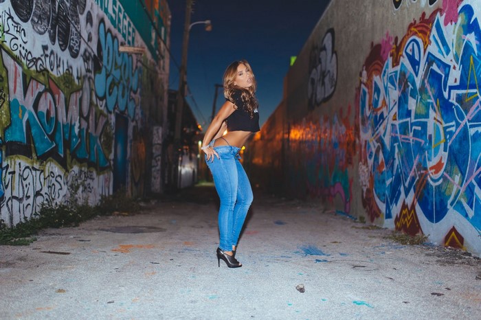 Nicole Mejia posing in a graffiti alley
