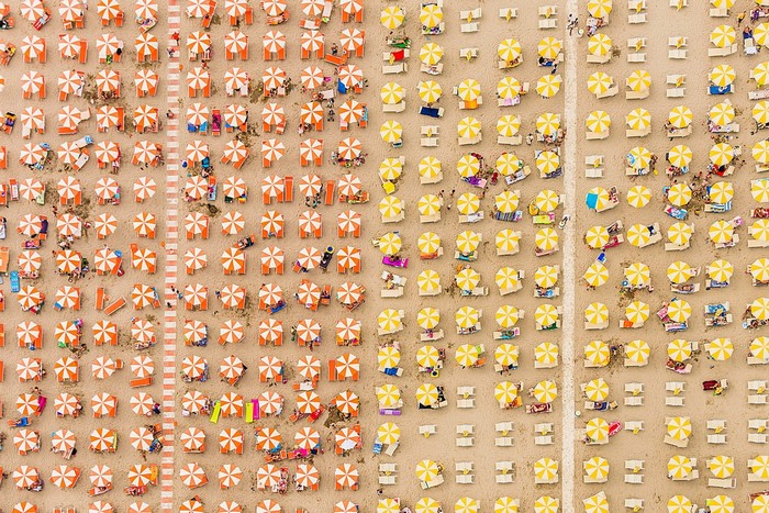Aerial View of Patterned Beach Umbrellas and People