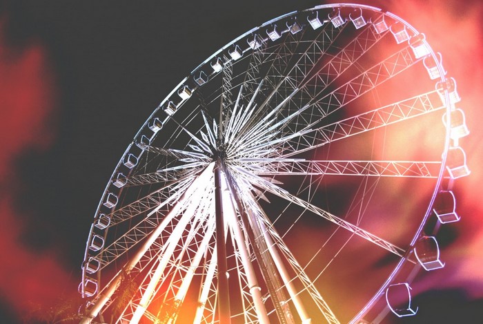 Ferris wheel at night with red and orange lights