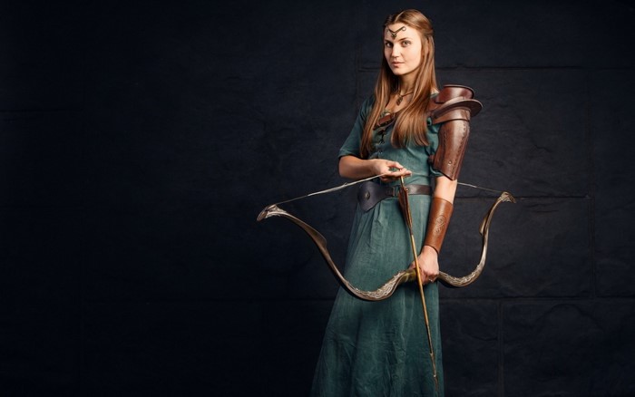 Woman in fantasy costume with bow and arrow