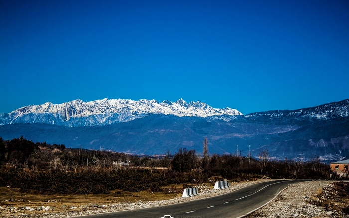 Snow-capped mountains and a road