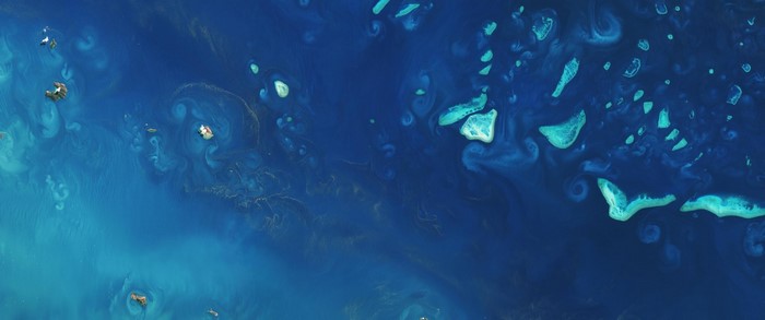 Aerial view of coral reefs and islands in the ocean