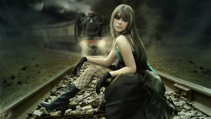 Woman sitting on train tracks with a train approaching