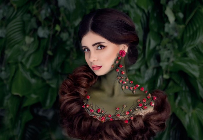 Woman with floral body paint and elaborate hairstyle